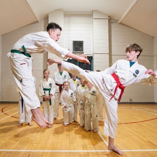 Student performing a high kick during Kick-Fit Taekwon-Do training session.