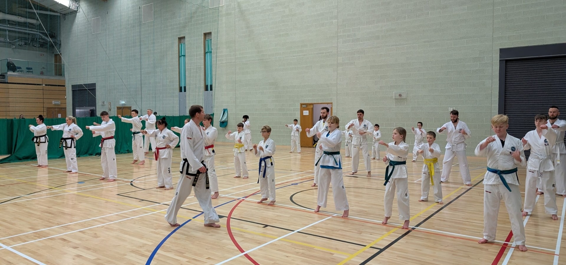 Students practising Taekwon-Do in a group class at Elite Taekwon-Do NI training hall in Northern Ireland.