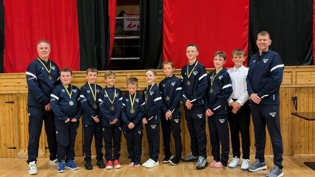 Elite Taekwon-Do NI team members posing at a competition event